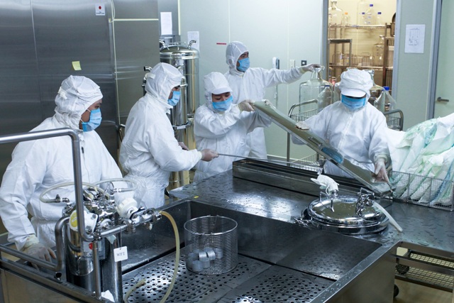Các cán bộ kỹ thuật đang làm việc trong dây chuyền sản xuất vắc xin Sởi-Rubella